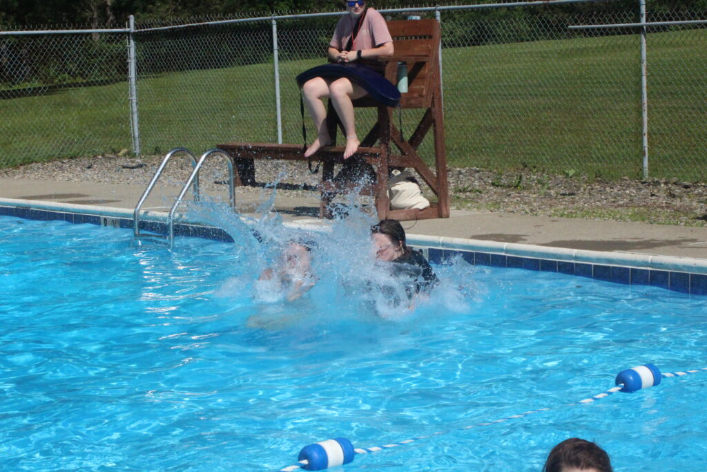 girls jumping in pool